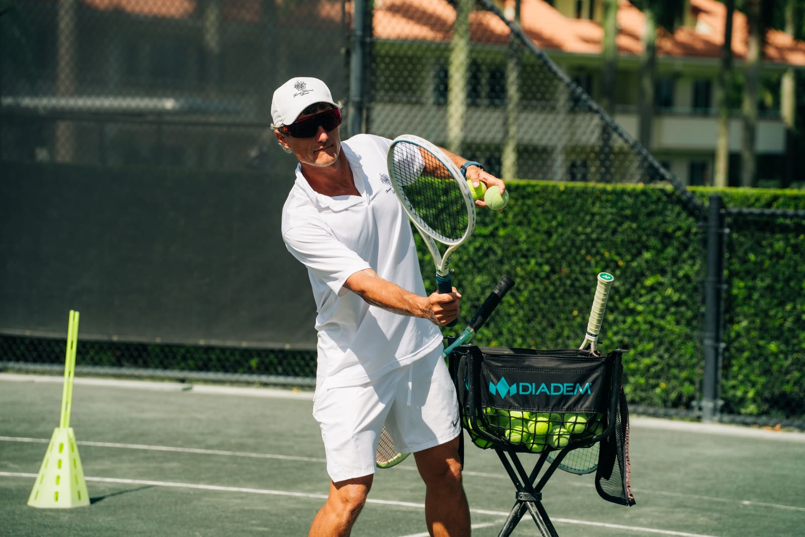 Coach feeding balls during a lesson