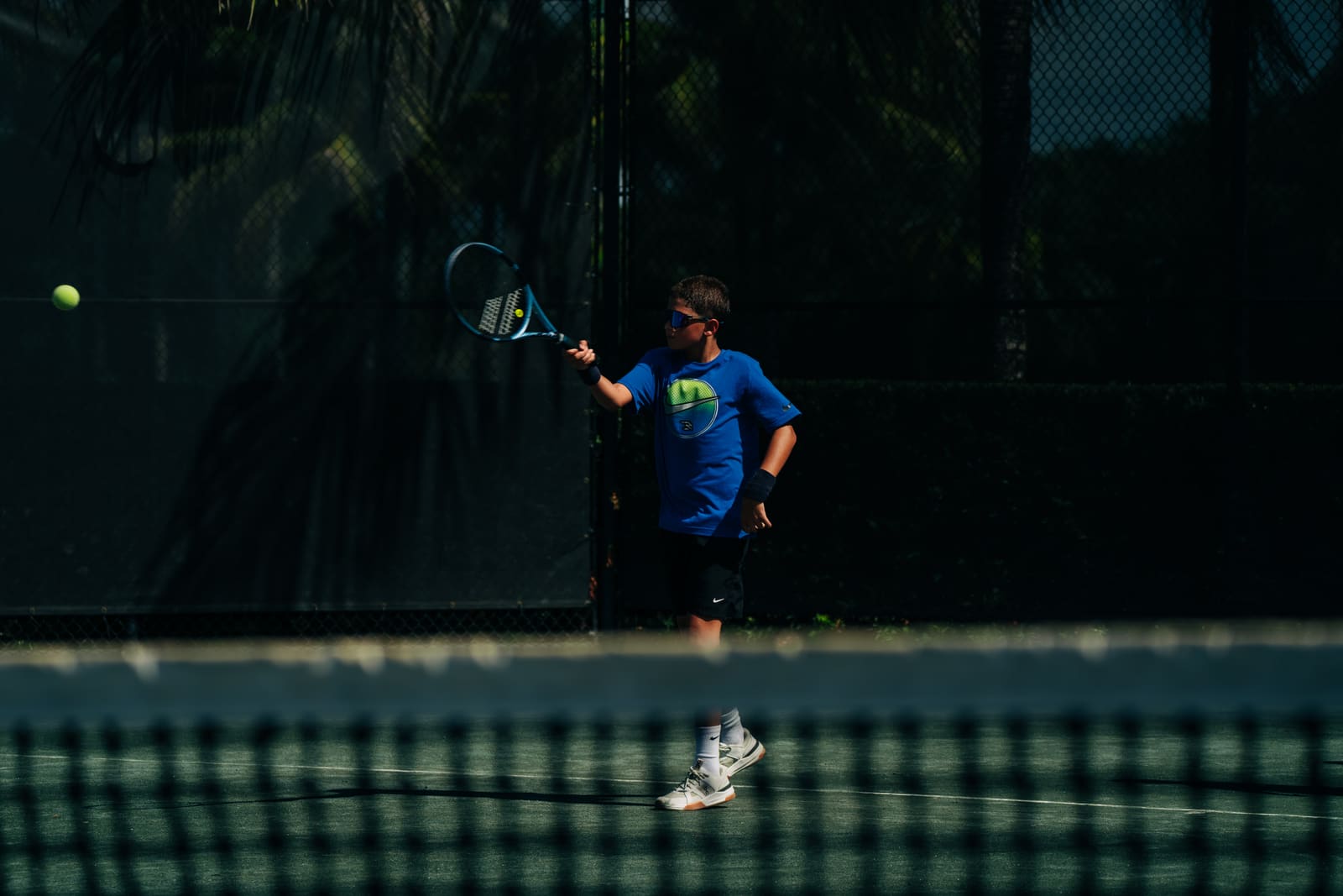 Player tossing a ball on the back fence
