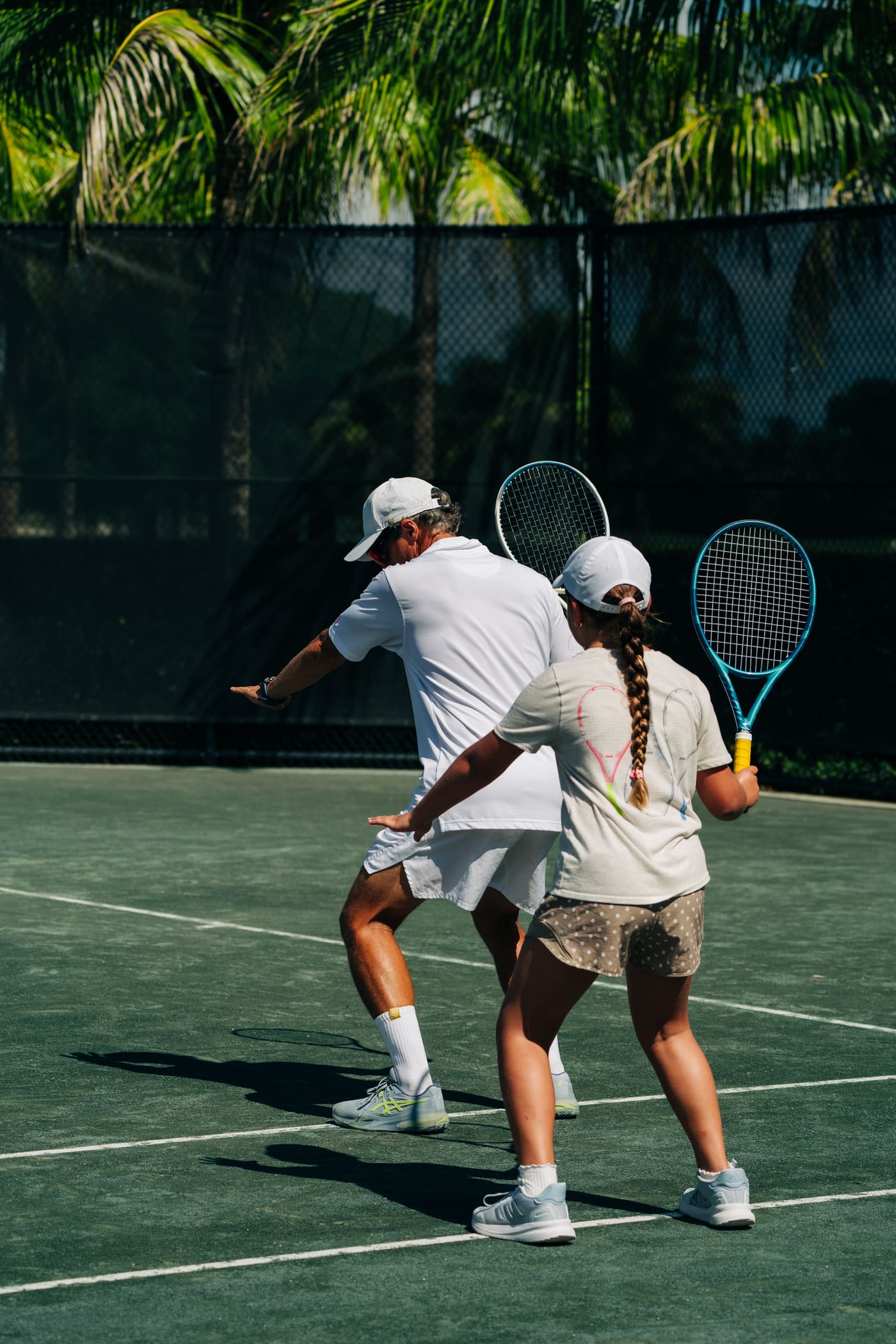 Coach and junior standing on the baseline