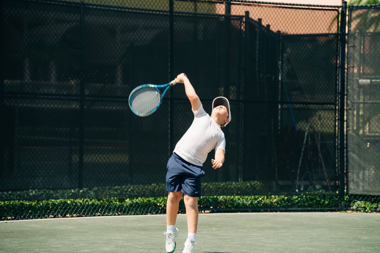 Junior tossing up a serve
