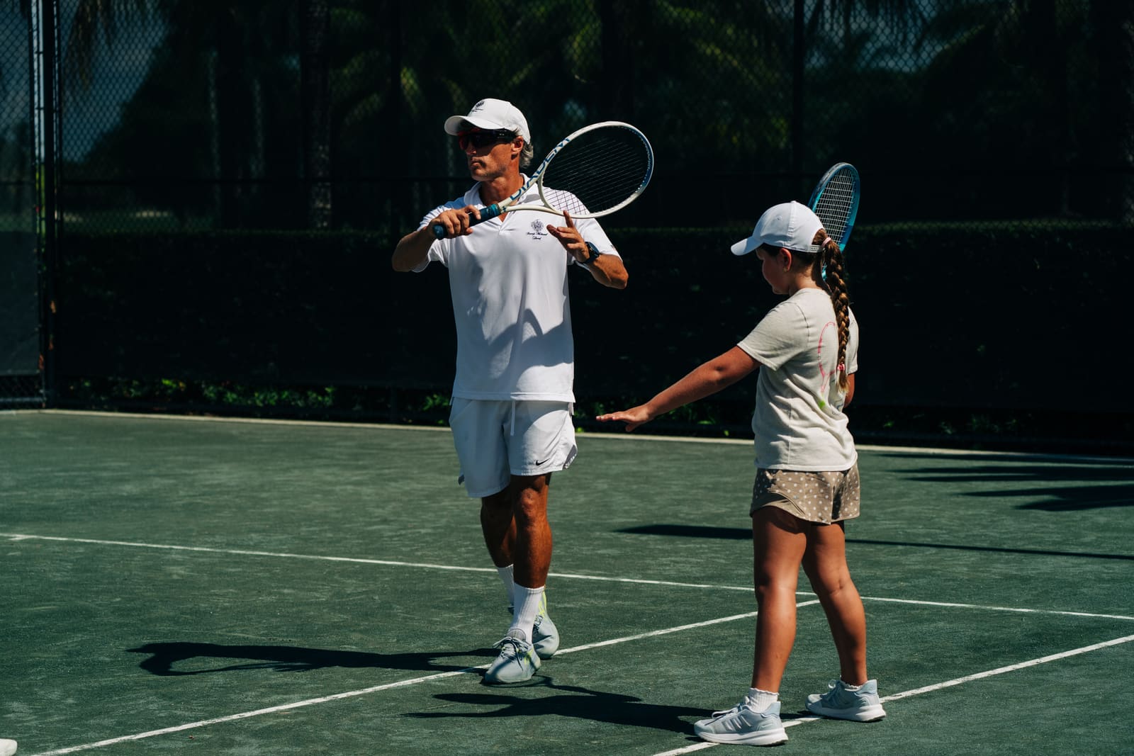 Coach and junior facing each other mid-lesson