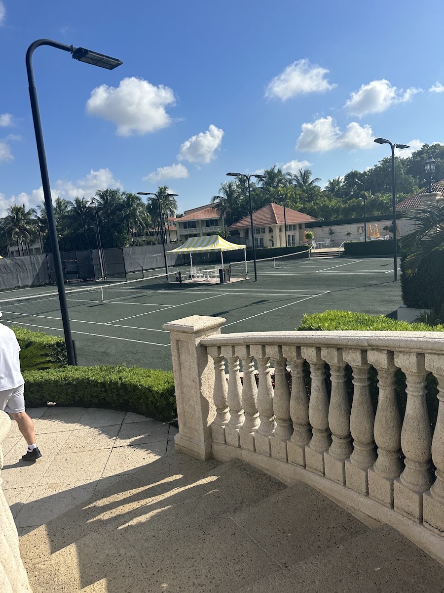 Green hard courts from the clubhouse stone staircase